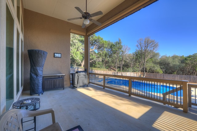 view of patio with a fenced in pool and ceiling fan