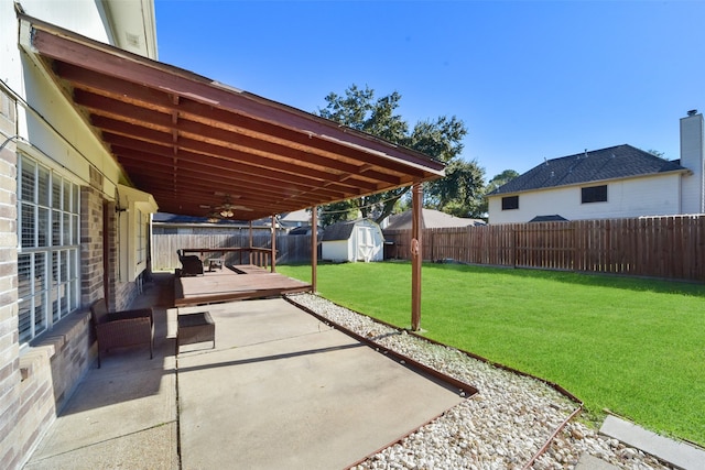 view of patio / terrace with a storage shed and a wooden deck