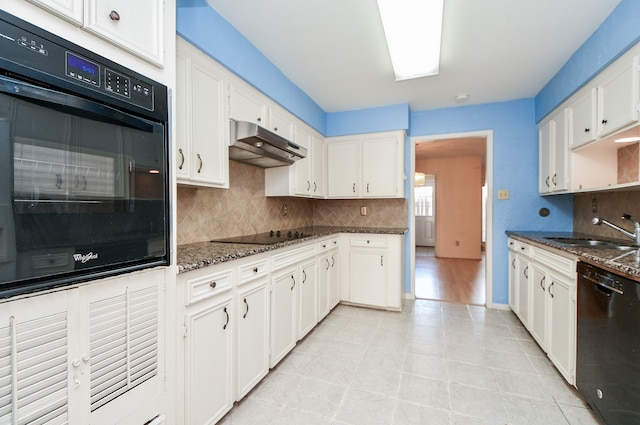 kitchen featuring black appliances, dark stone countertops, white cabinetry, and sink