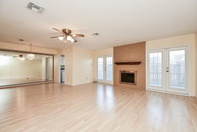 unfurnished living room with ceiling fan, light hardwood / wood-style flooring, and french doors