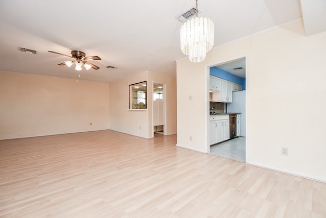 unfurnished living room with light hardwood / wood-style flooring and ceiling fan with notable chandelier