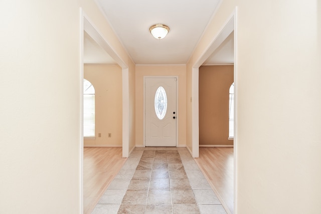 entrance foyer with light hardwood / wood-style flooring and ornamental molding