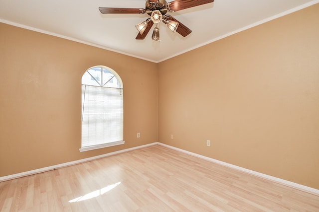 empty room with ceiling fan, crown molding, and light hardwood / wood-style flooring