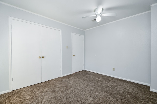 unfurnished bedroom featuring dark colored carpet, ceiling fan, and crown molding