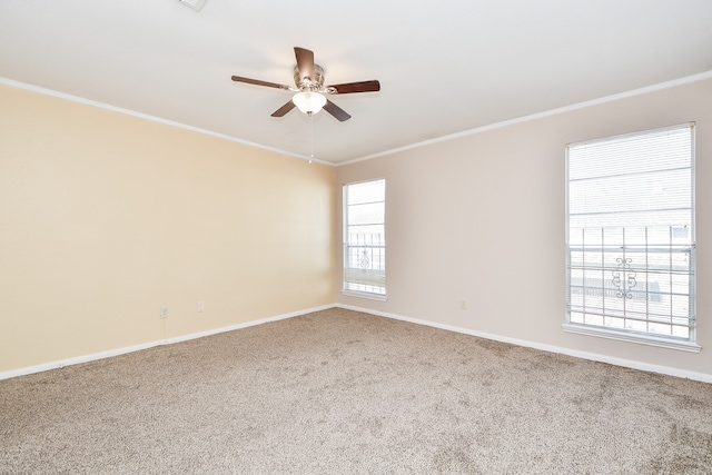 spare room with crown molding, carpet floors, and a healthy amount of sunlight