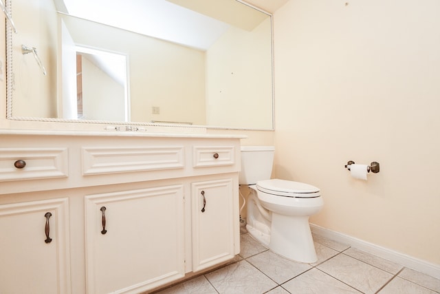 bathroom with tile patterned floors, vanity, and toilet