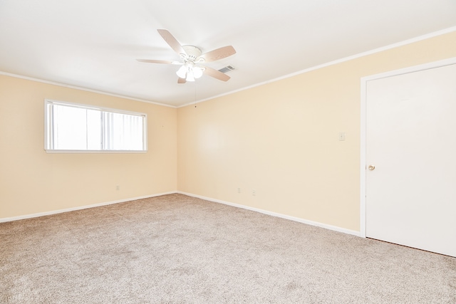 empty room with carpet floors, ceiling fan, and crown molding