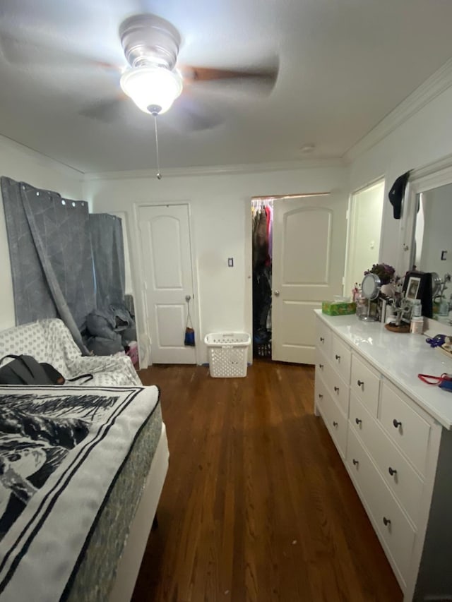 bedroom featuring crown molding, ceiling fan, and dark wood-type flooring