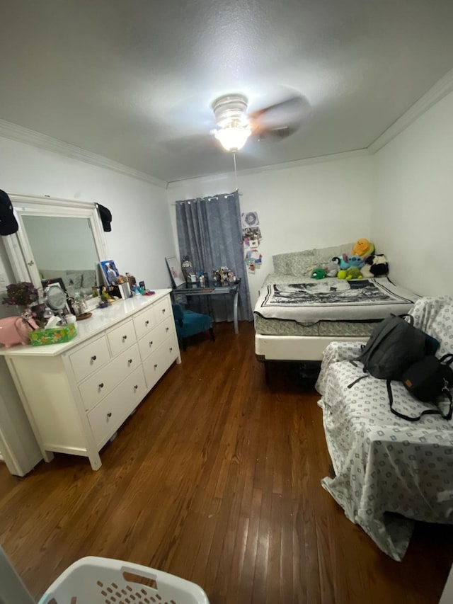 bedroom with dark hardwood / wood-style floors, ceiling fan, and ornamental molding