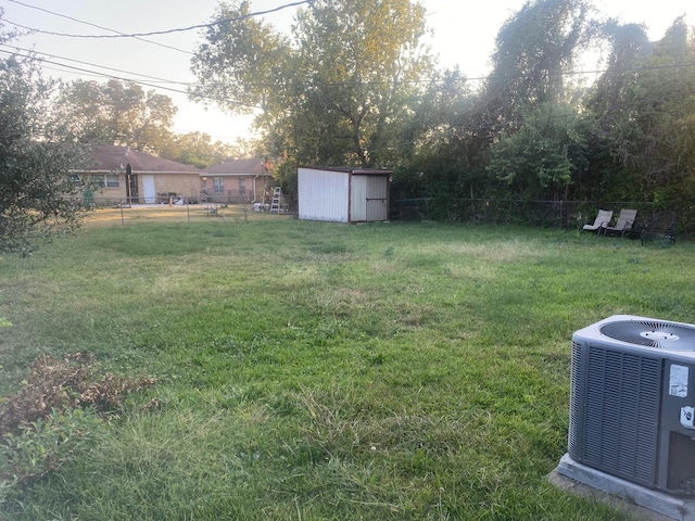 view of yard featuring a shed and cooling unit