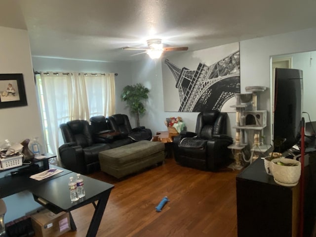 living room with wood-type flooring and ceiling fan