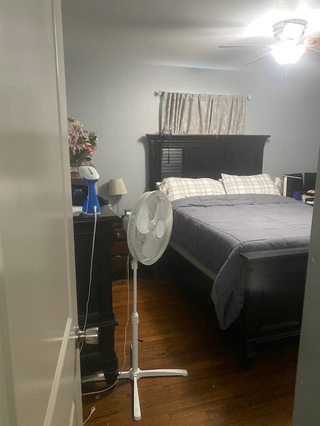 bedroom with ceiling fan and dark wood-type flooring