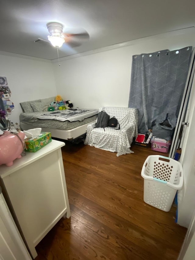 bedroom featuring ceiling fan, dark hardwood / wood-style floors, and ornamental molding