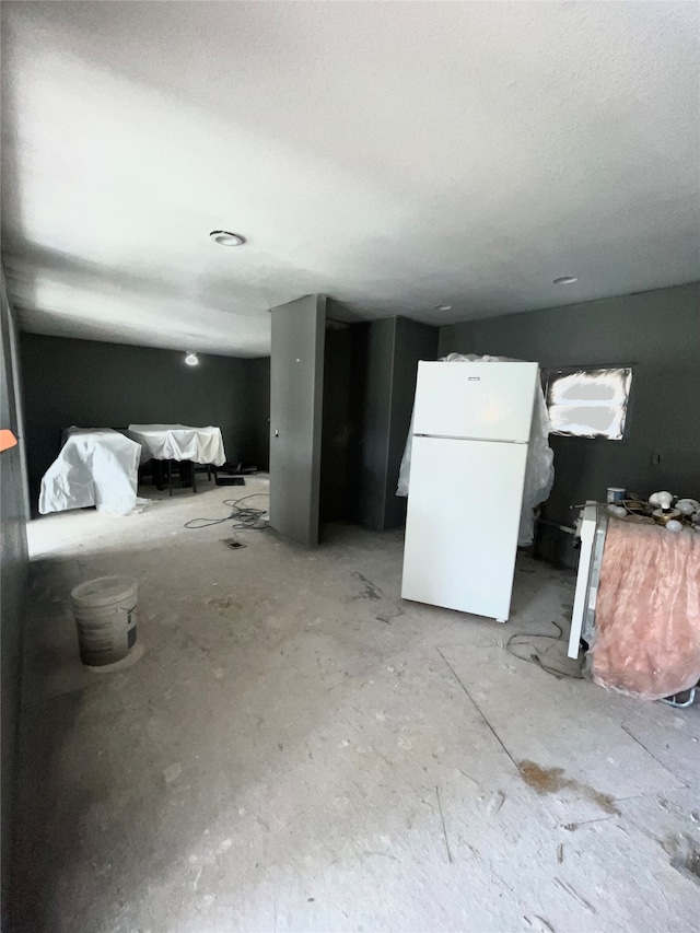 interior space featuring white cabinets and white fridge