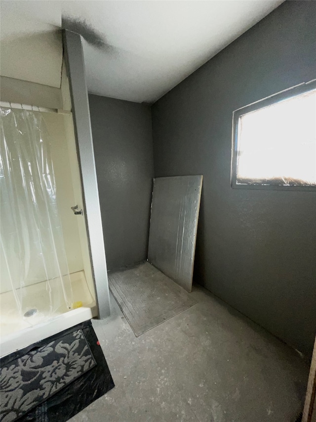 bathroom featuring a shower with curtain and concrete flooring