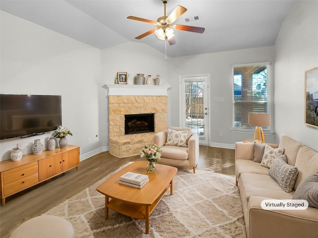 living room with a fireplace, dark hardwood / wood-style flooring, ceiling fan, and lofted ceiling