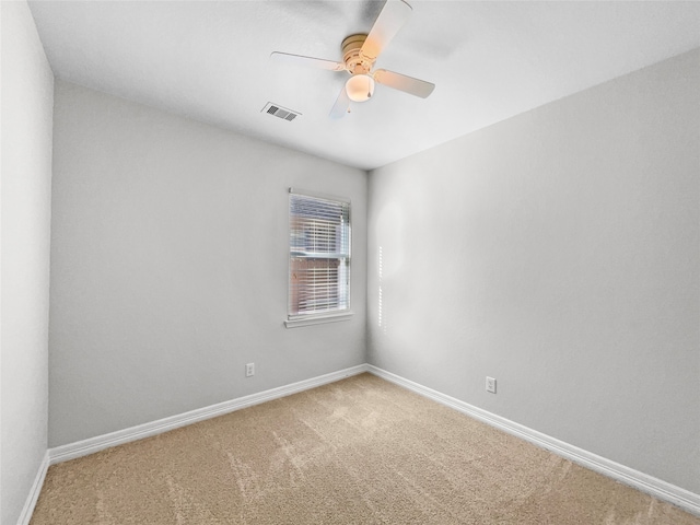 empty room with ceiling fan and carpet floors