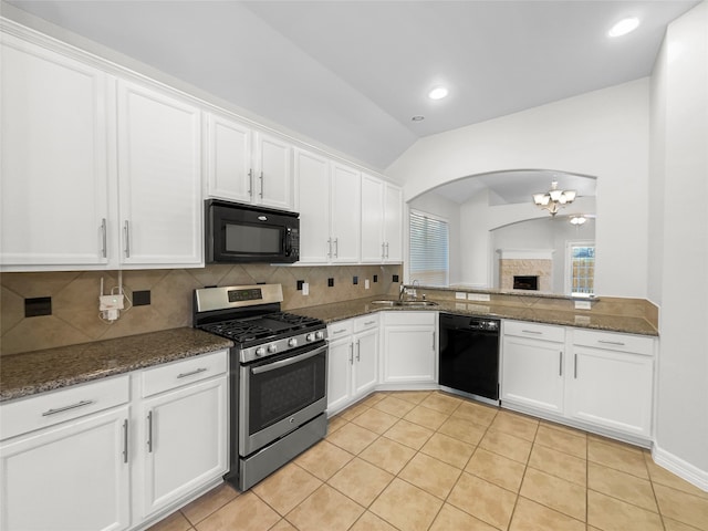 kitchen with lofted ceiling, black appliances, light tile patterned floors, tasteful backsplash, and white cabinetry