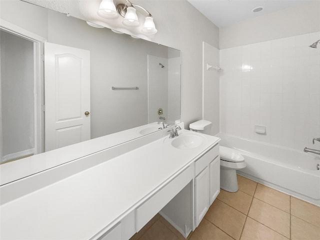 full bathroom with tile patterned floors, vanity, tiled shower / bath, and toilet