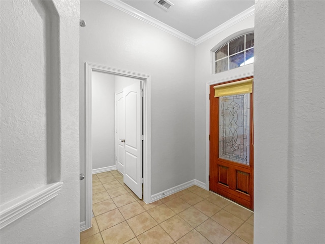 tiled entryway featuring crown molding