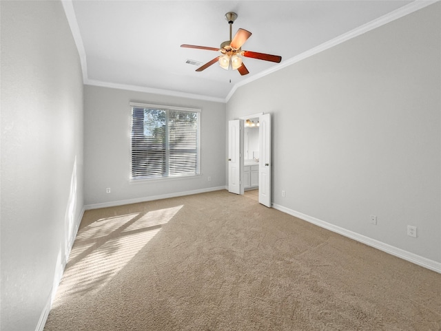 unfurnished bedroom with ceiling fan, light colored carpet, vaulted ceiling, and ornamental molding