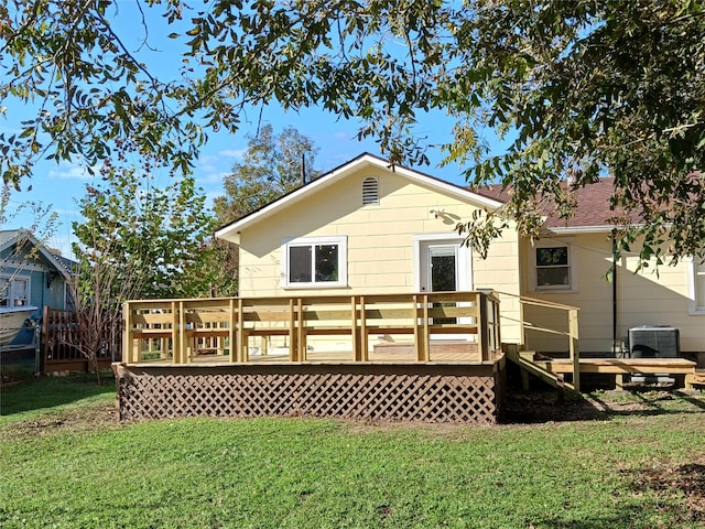 rear view of house featuring a lawn, central AC, and a deck