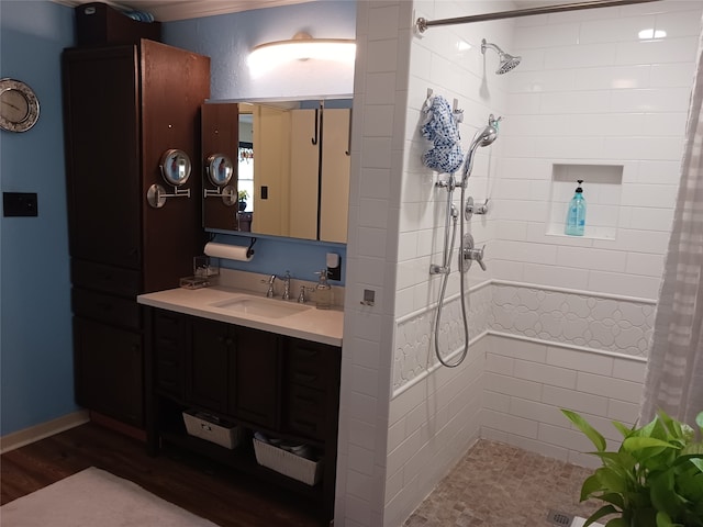 bathroom with hardwood / wood-style flooring, vanity, and curtained shower