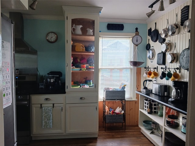 kitchen with ventilation hood, dark hardwood / wood-style floors, white cabinetry, and crown molding