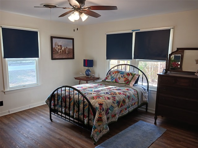 bedroom with ceiling fan and dark wood-type flooring