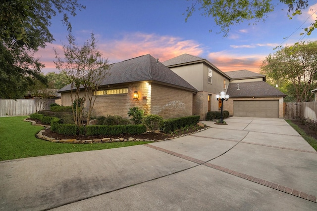 view of front of property with a garage and a lawn