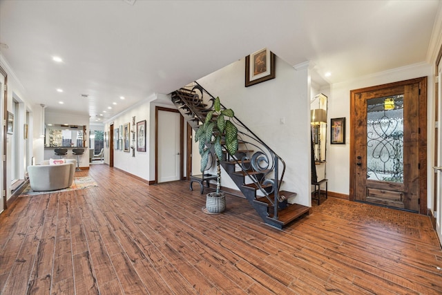 foyer entrance featuring ornamental molding and wood-type flooring