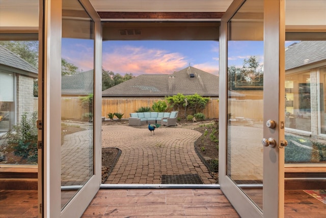 doorway to outside with french doors, hardwood / wood-style floors, and a healthy amount of sunlight