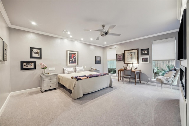 bedroom with ceiling fan, light colored carpet, multiple windows, and crown molding