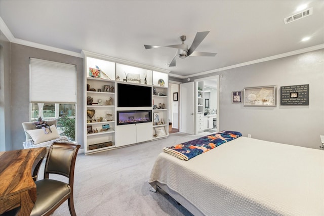 carpeted bedroom featuring ensuite bathroom, ceiling fan, and ornamental molding