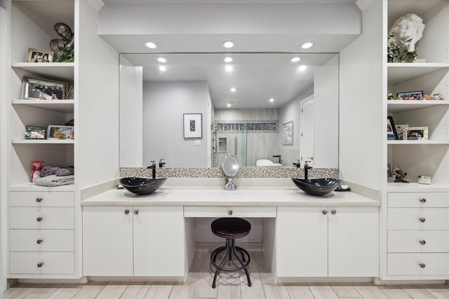 interior space featuring a shower with door and vanity