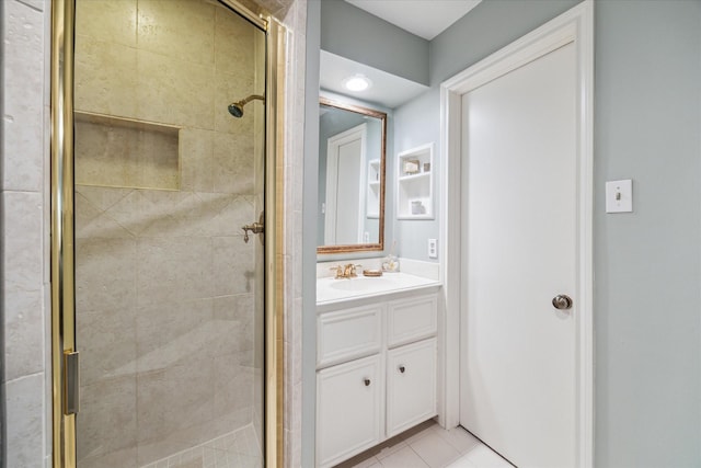 bathroom with an enclosed shower, tile patterned flooring, and vanity