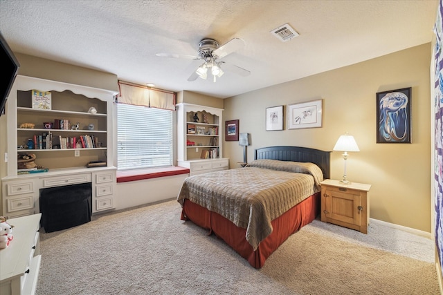 carpeted bedroom with a textured ceiling and ceiling fan