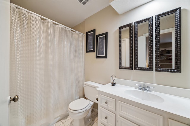 bathroom featuring toilet, tile patterned flooring, and vanity