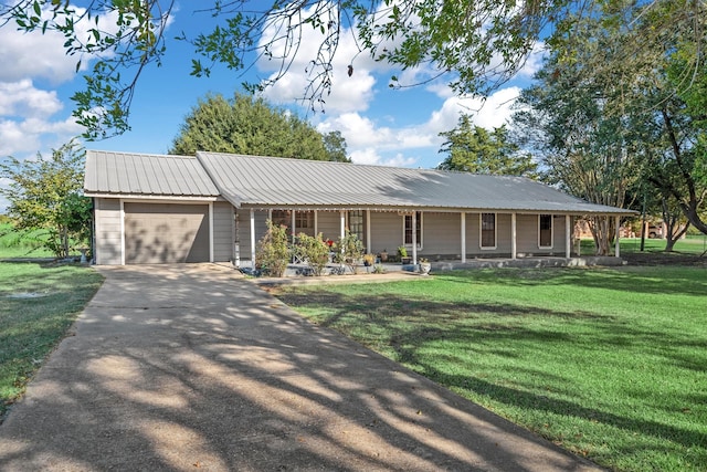 view of front of house featuring a front yard, a porch, and a garage