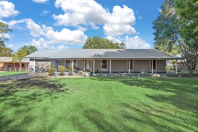 view of front of property with a porch, a garage, and a front lawn