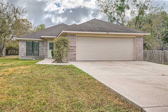 ranch-style home with a front lawn and a garage