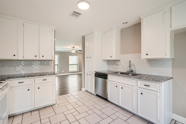 kitchen with white cabinetry, dishwasher, ceiling fan, and dark stone counters