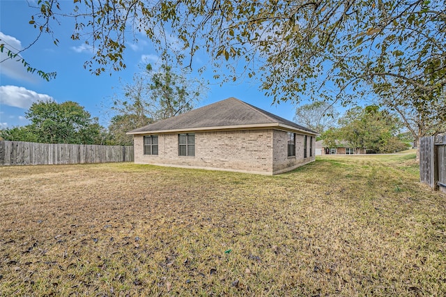 back of property with a lawn