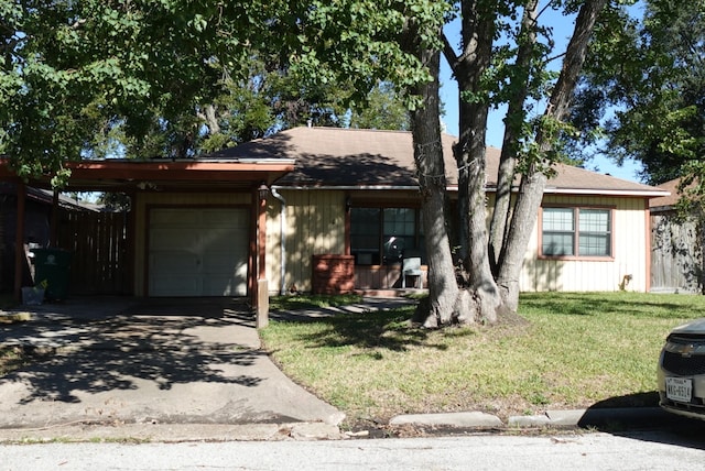 view of front of home with a front yard and a garage