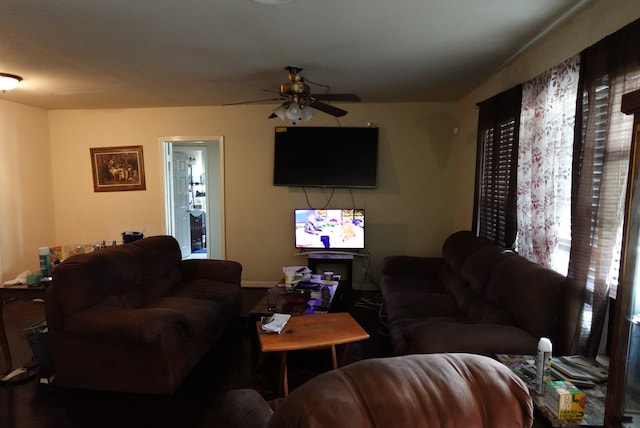 living room with a wealth of natural light and ceiling fan