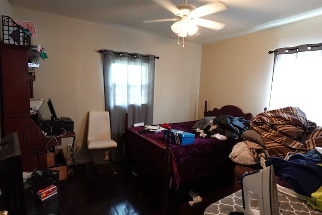 bedroom with ceiling fan and dark hardwood / wood-style flooring