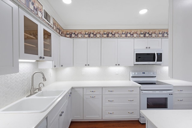 kitchen featuring dark hardwood / wood-style flooring, tasteful backsplash, sink, electric range, and white cabinets