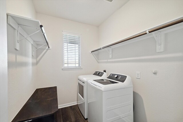 clothes washing area featuring dark hardwood / wood-style flooring and washing machine and dryer