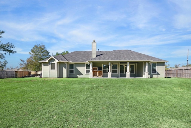 back of house with a lawn