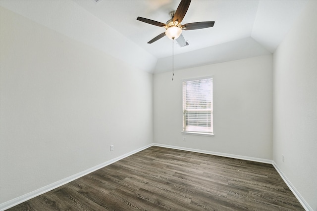 spare room with dark hardwood / wood-style floors, ceiling fan, and vaulted ceiling